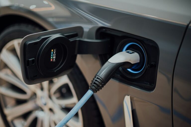 Tesla Q3 earnings – electric vehicle charging cable plugged into a car